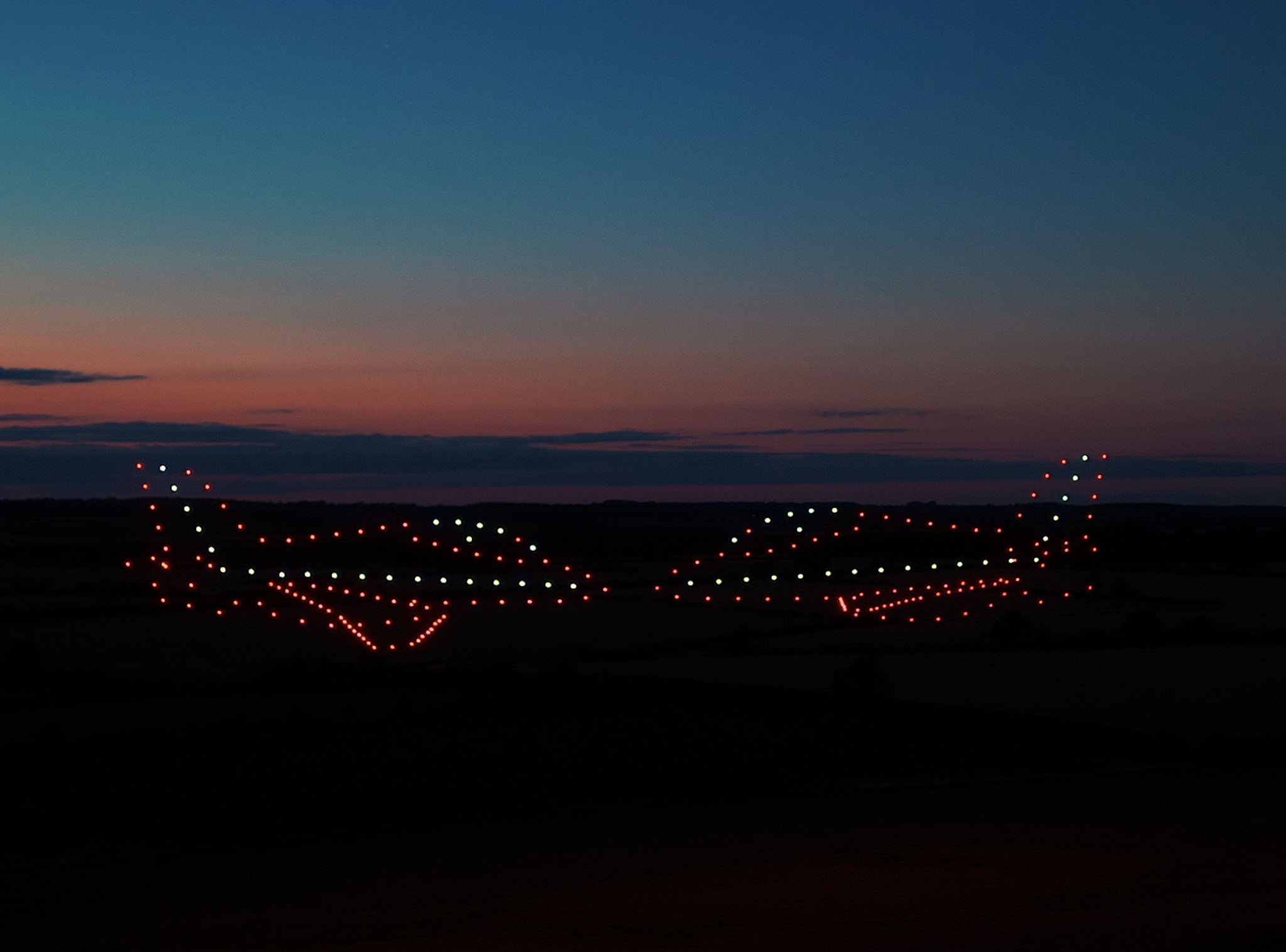 Red Arrow jets made from 225 drones fly past each other at the BMFA National Centre